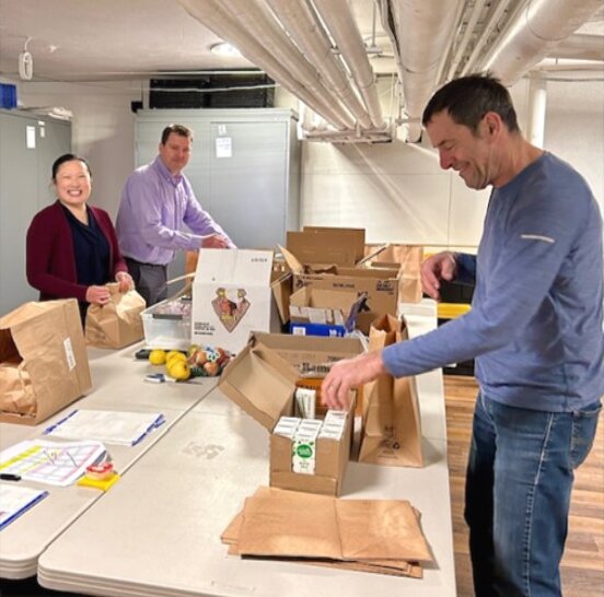 Chapter members packing donated food into bags at a community service project